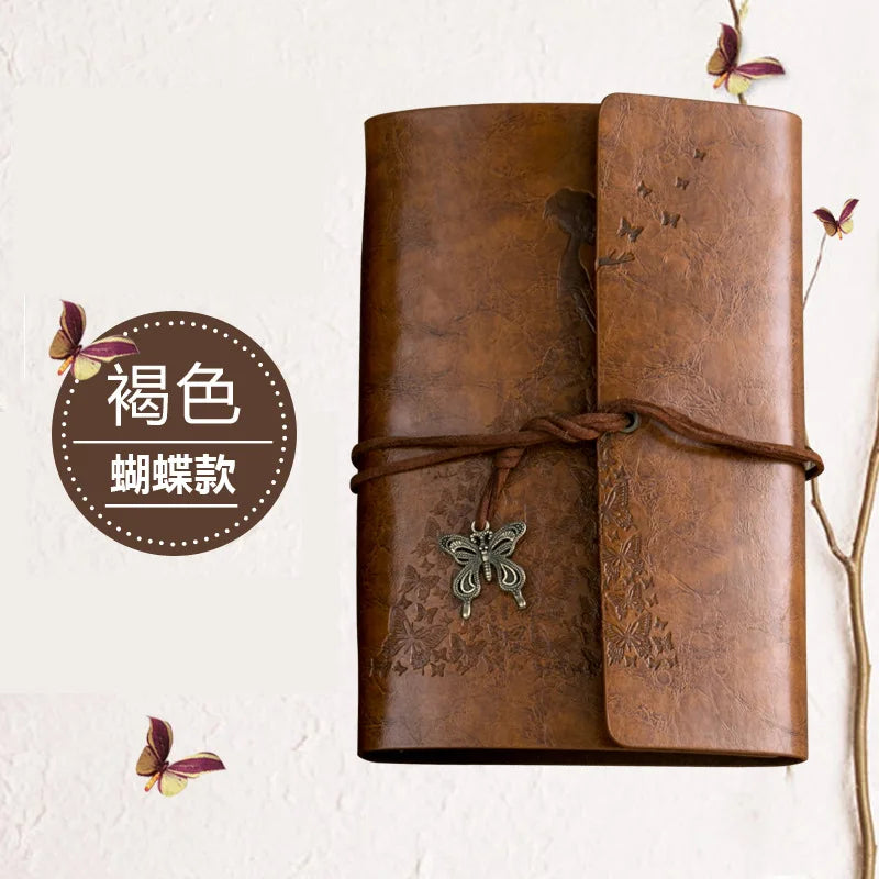 A brown leather journal notebook with embossed butterfly designs and a leather tie.