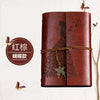 A brown leather journal notebook with embossed butterfly designs and a leather tie.