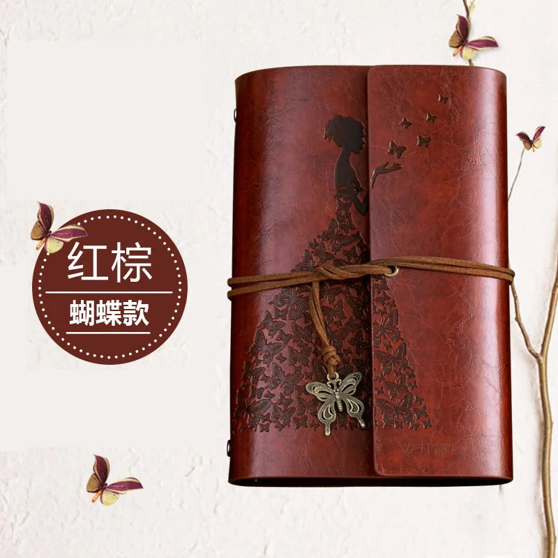 A brown leather journal notebook with embossed butterfly designs and a leather tie.