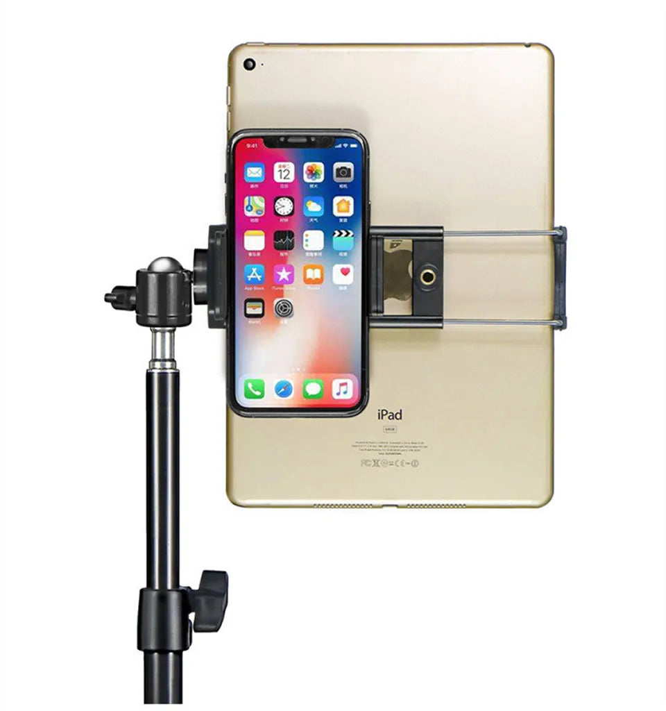 A beige iPad is mounted on an adjustable clamp, holding an iPhone in place.