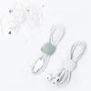 White silicone cable organizer clips with multiple wires and connectors