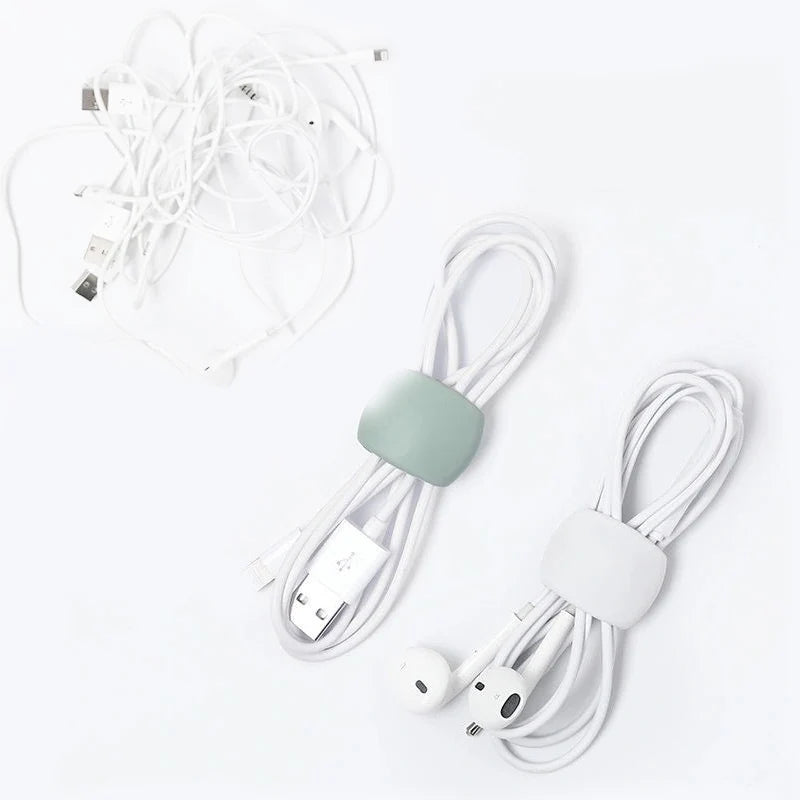White silicone cable organizer clips with multiple wires and connectors