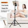 A woman is using an adjustable tripod stand to hold a tablet, demonstrating its versatility for mobile devices.
