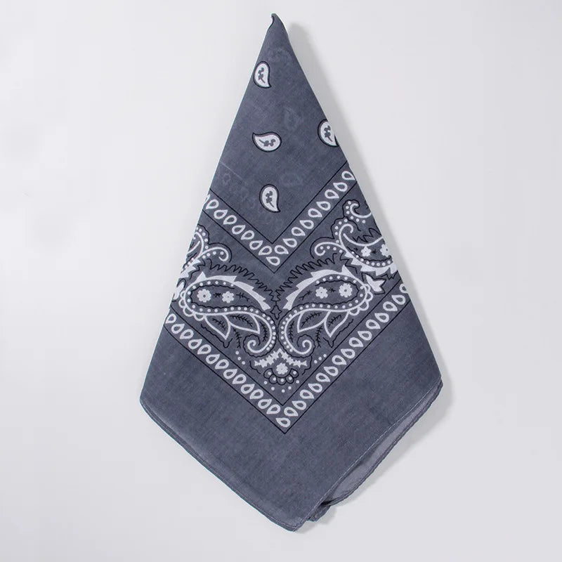 A dark blue cotton bandana square scarf featuring an intricate white paisley print.