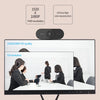 A computer monitor displaying a video call with several people, next to an 1080P HD webcam.