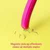 A pink magnetic pick-up tool effortlessly cleans up multiple metal staples on a yellow background.