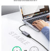 A hand connects a USB to Ethernet adapter to a laptop, demonstrating a wired Gigabit network connection versus Wi-Fi.