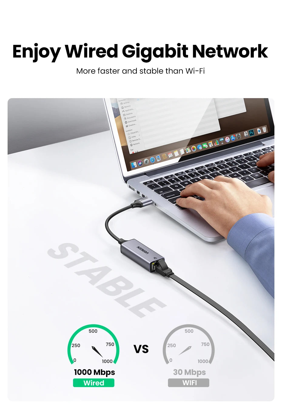 A hand connects a USB to Ethernet adapter to a laptop, demonstrating a wired Gigabit network connection versus Wi-Fi.