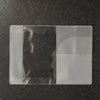 A transparent PVC passport and ID holder wallet lying on a dark surface.