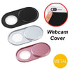 A set of ultra-thin magnetic webcam privacy covers in black, silver, and pink metal.