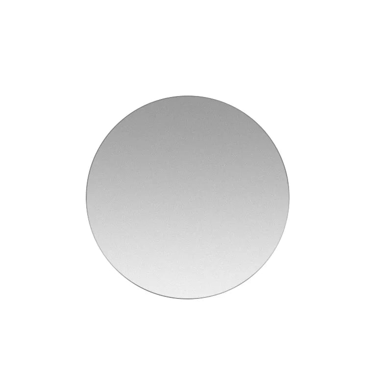 A round, silver magnetic mount plate for phones and devices.