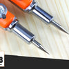 A close-up view of an orange and silver adjustable woodworking marking compass with a sharp point resting on a light wooden s