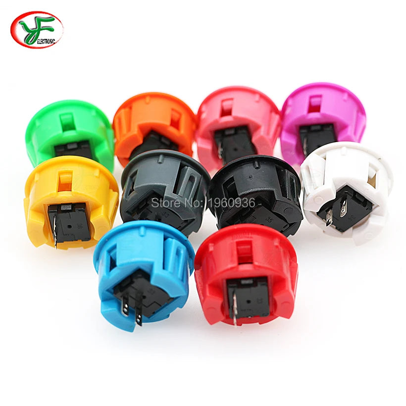 A collection of colorful arcade push button game switches in various colors including green, orange, pink, yellow, black, blu