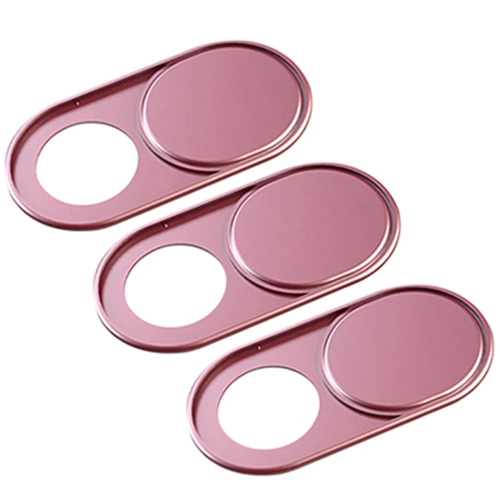 A set of three pink magnetic privacy covers for a webcam.