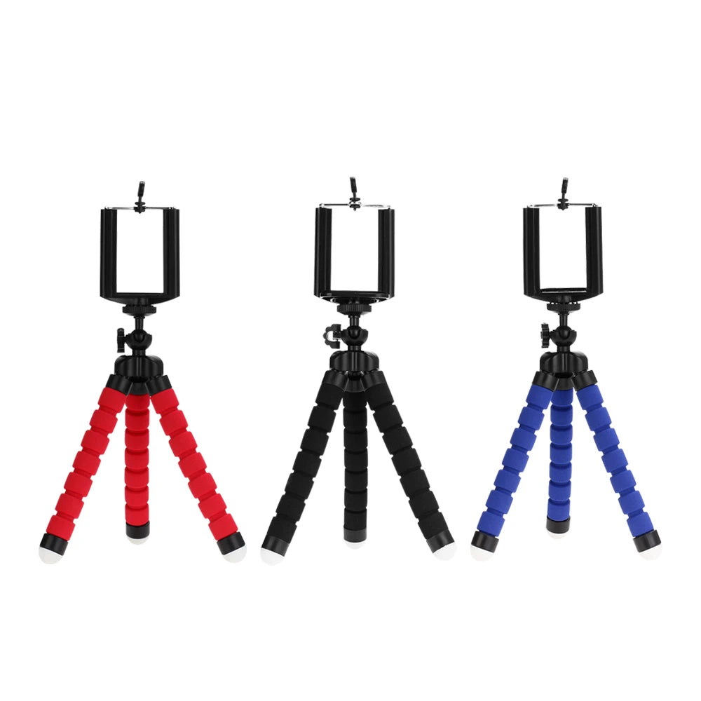 Three flexible mini tripods in black, red, and blue with phone clips for smartphone and camera.