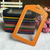 An orange PU leather ID card holder with a loop is displayed in front of a stack of colorful plastic cards.