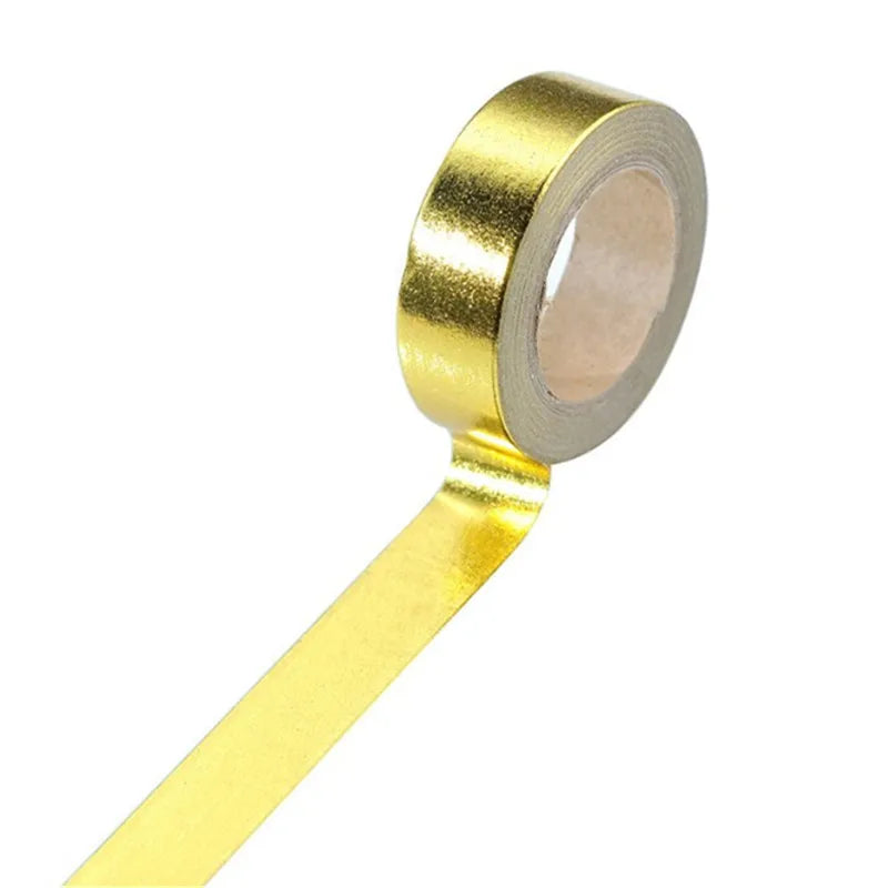 Roll of decorative gold foil washi tape with a thin paper backing and a yellow adhesive strip.