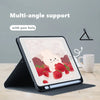 A tablet displaying a pink composition book cover design with a rabbit and strawberries, shown with a multi-angle support.