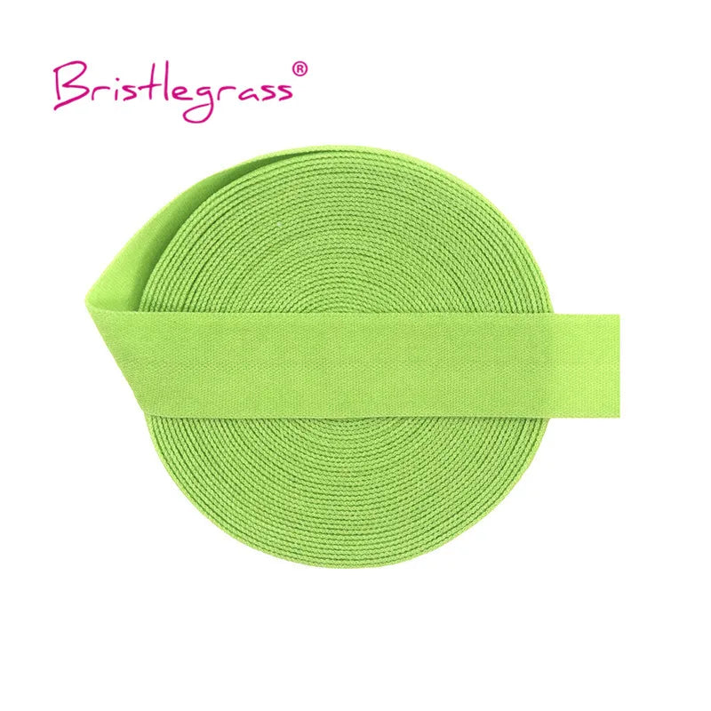 A bright lime green elastic hair tie or trim, coiled and wrapped around a band.
