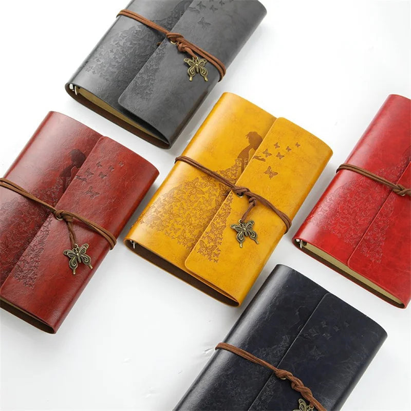 A set of four vintage butterfly PU leather A6 journal notebooks in shades of red, yellow, and dark blue.