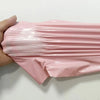A hand holds a pink waterproof self-seal poly mail bag, showing its flexible and sealed nature.