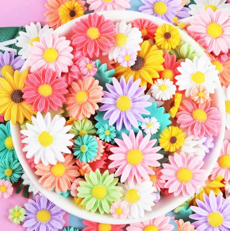 A colorful assortment of pink, yellow, and white sunflower flatback resin cabochons for crafts