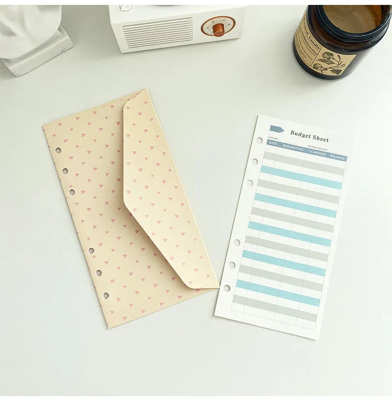 A set of twelve budget planner cards in six colors, including a budget sheet and envelope cards.
