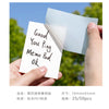 A hand holds a white memo pad and a transparent sheet, showing the product size and packaging.