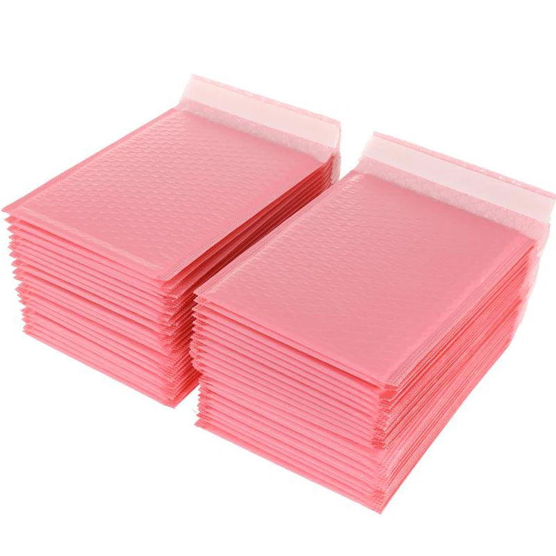 A stack of pink self-sealing bubble mailers or padded envelopes.