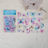 A collection of colorful butterfly wings in a clear plastic sheet for scrapbooking and journaling