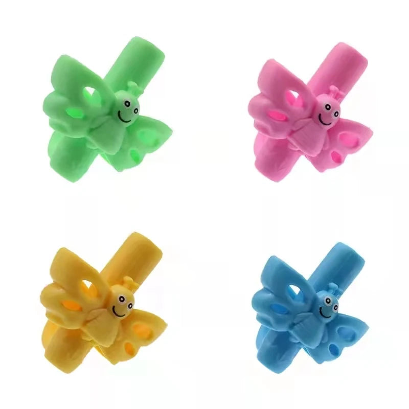 Three silicone pencil grips in green, pink, and yellow for children's handwriting aid.