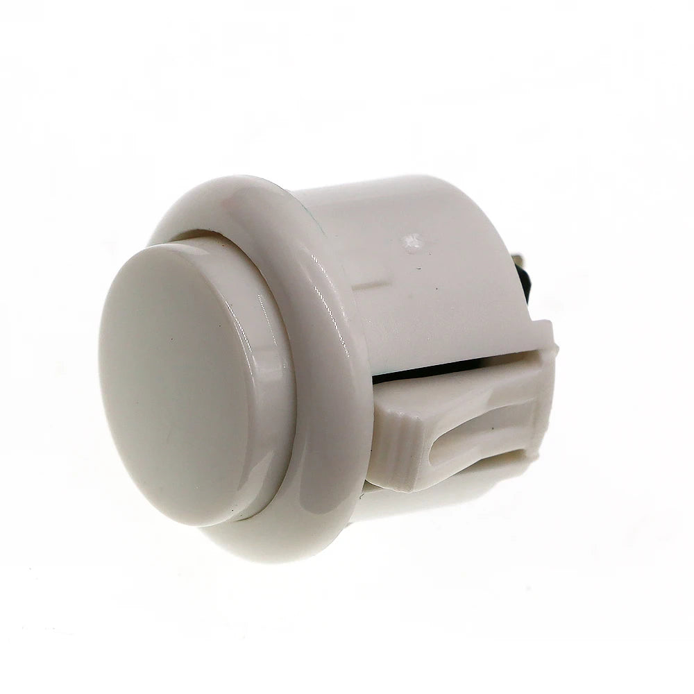A white arcade push button game switch with a round, plastic housing and a rectangular connector.