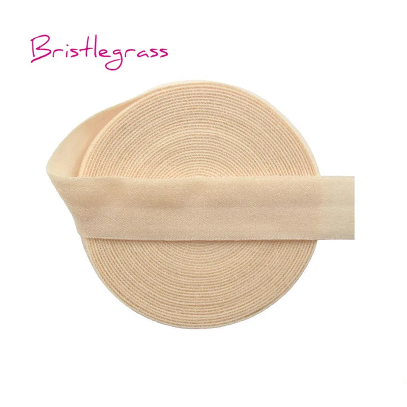A beige bristleglass hair tie with a thin elastic band wrapped around the middle.
