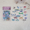 A collection of colorful butterfly wings printed on clear PET stickers for scrapbooking and journaling.