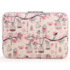 A pink floral patterned canvas laptop sleeve with a zippered closure featuring hanging birdcage designs.