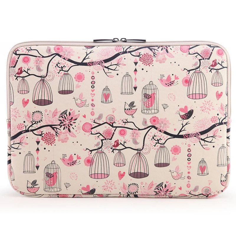 A pink floral patterned canvas laptop sleeve with a zippered closure featuring hanging birdcage designs.