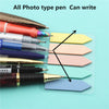 Various photo-type pens writing on colorful transparent sticky note memo pads