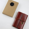 A vintage brown box and a leather-bound A6 journal notebook with a brass clasp.