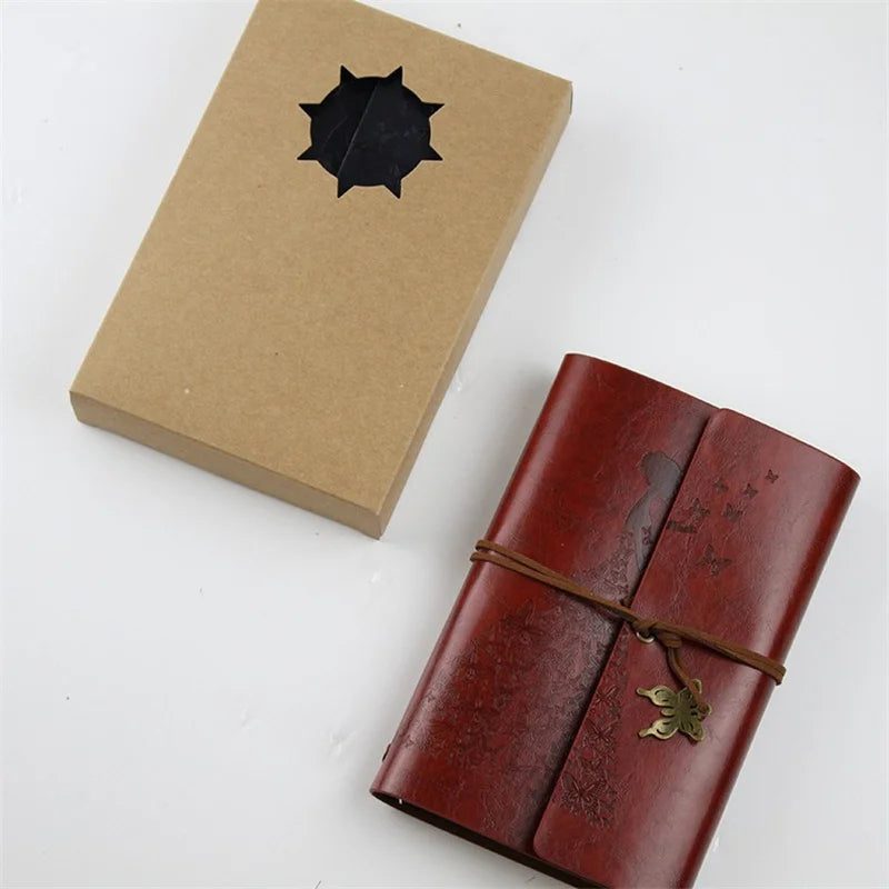 A vintage brown box and a leather-bound A6 journal notebook with a brass clasp.