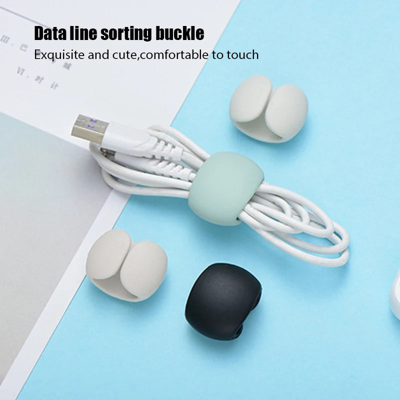 A white silicone cable organizer with multiple clips and a black connector is shown on a light blue background.