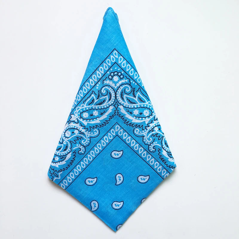 A bright blue cotton bandana square scarf featuring an intricate white paisley print.