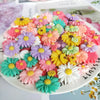 A colorful arrangement of pink, yellow, purple, and green sunflower resin cabochons for crafts.