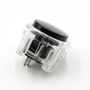 A clear plastic arcade push button game switch with a black dome top and metal pins.