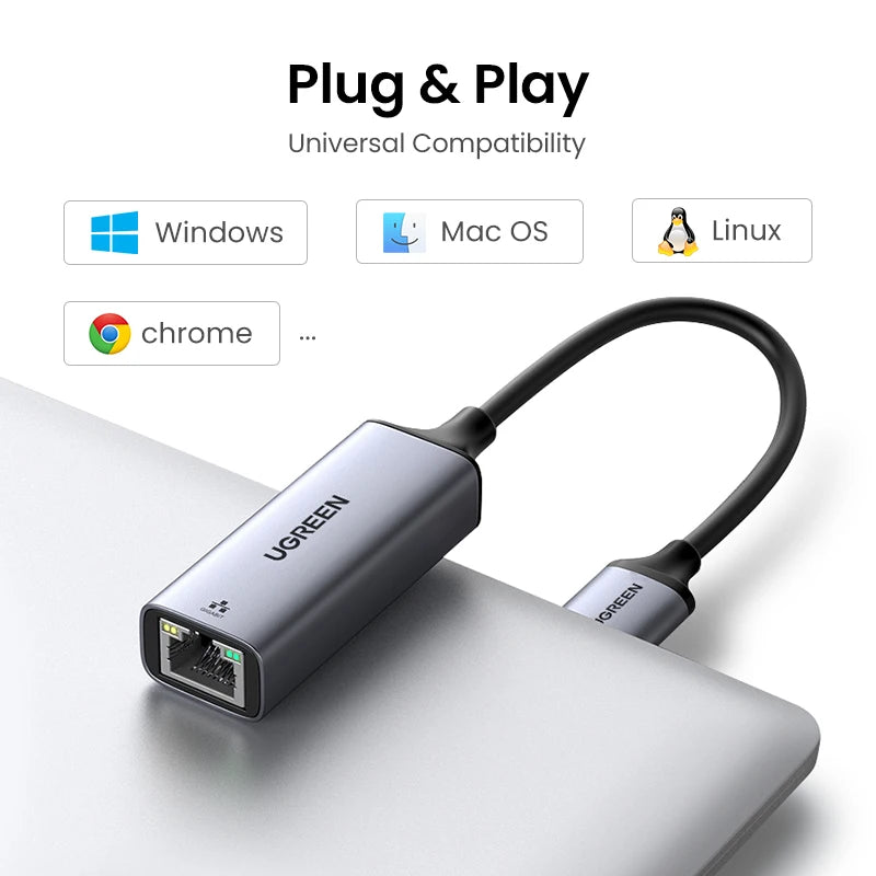 A silver UGREEN USB to Ethernet adapter plugged into a laptop, demonstrating plug and play universal compatibility.