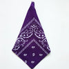 A purple cotton bandana square scarf featuring a white paisley print.