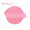 Pink bristleglass elastic hair ties and trims rolled into a circular shape