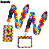 Buntes Puzzle-Teil-Muster-Lanyard mit schwarzem Band und Schlüsselring aus klarem Kunststoff.