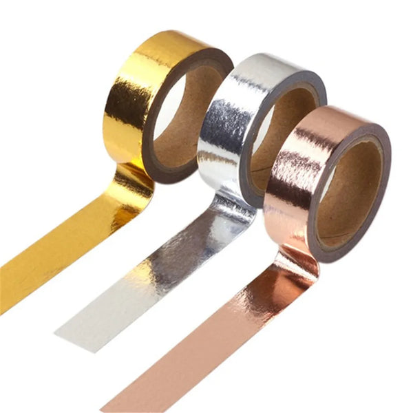 A set of three rolls of decorative gold, silver, and rose gold foil washi tape for crafting.