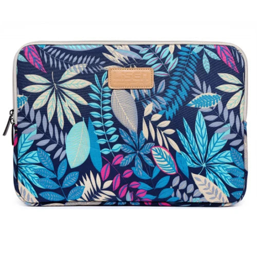 A dark blue canvas laptop sleeve featuring a vibrant tropical leaf pattern and a light tan leather accent.