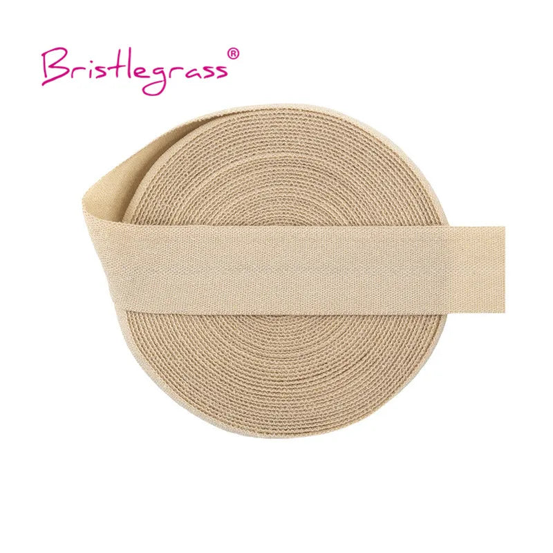 A beige elastic hair tie with a thin band, shown flat.